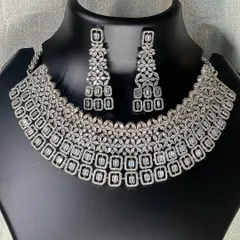 A clear, still photo of the silver American diamond choker set. The matching earrings complete this elegant set, making it a reliable choice for your next event.