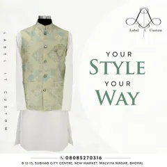 This is a studio shot of one of my ready-to-customize Nehru jacket sets. The jacket features a subtle light green and cream pattern, paired with a classic white kurta. It’s a great example of an understated yet elegant ethnic look.