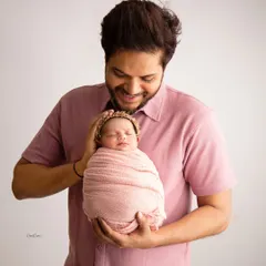 There's a special kind of safety a baby feels in their father's hands. This portrait is all about that gentle, protective bond between a dad and his brand new baby girl.