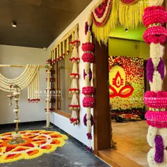 A glimpse into a home we decorated for a Gruha Pravesha. The entrance is adorned with traditional flower garlands and a beautiful 'pookalam' (floral rangoli), setting a festive and auspicious tone right from the doorstep.