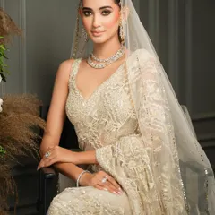 An ethereal look for the modern bride. This ivory Nitika Gujral saree, paired with delicate diamond jewelry, is the definition of grace. My styling focused on a clean, elegant drape to let the intricate lacework shine.