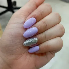 An accent nail is a great way to add sparkle without overwhelming the look. Here, I paired a soft lavender gel polish on oval nails with a single, full-coverage silver glitter nail for a chic and balanced manicure.