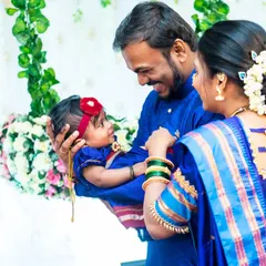 A heartwarming photo of parents looking lovingly at their baby girl during her Naming Ceremony.