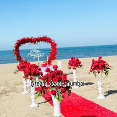 A slightly different angle of the beach proposal decor, showing the 'Will you Marry Me?' sign and the table setting more clearly. I ensure every detail is perfect for your photos.