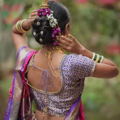 A complete bridal artist needs to be a skilled hairstylist. I teach traditional hairstyles like this intricate Maharashtrian khopa, beautifully adorned with fresh flowers, a timeless look for any bride.