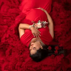 A sea of red for a queen. This dramatic overhead shot uses a voluminous red gown to create a stunning, artistic portrait that is all about celebrating the power and passion of motherhood.