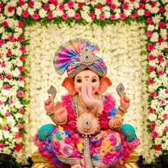 I love working with clients year after year to create their dream Ganpati decor. This setup features a beautiful arch of pink and white flowers over a dense white floral backdrop, perfectly complementing the client's colorful idol.