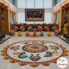 The entrance to this corporate office was transformed with a grand and detailed rangoli featuring peacock designs made from colored powder and flower petals. This large scale floor art, combined with colorful umbrellas and traditional decor, made for a spectacular welcome.