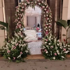 The same floral entrance arch, showing how it frames the view into the main event space.