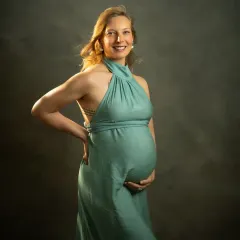 My studio sessions are designed to feel like a fine art sitting. This portrait of Sonia in a flowing green gown against a moody, classic backdrop highlights the elegance and strength of motherhood. The lighting is carefully shaped to create a painterly, three-dimensional feel.
