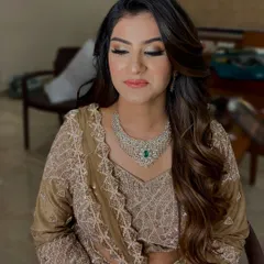 A beautiful, soft glam look perfect for an engagement or reception party. The focus is on shimmery eyelids, flawless skin, and a soft coral lip, paired with voluminous waves.