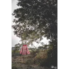 The bridal lehenga, hung in a natural setting. This artistic shot turns the wedding dress into a beautiful portrait of its own.