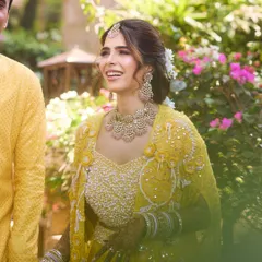 A candid, happy moment from the Haldi ceremony. The bride's natural smile shines through, enhanced by our subtle and luminous makeup.