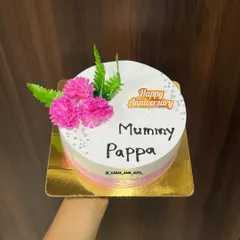 A simple and sweet anniversary cake for "Mummy Pappa," with pink ombre sides and fresh pink flowers.