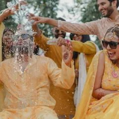 The groom gets a surprise splash from his friends during the Haldi celebrations. We are always ready to capture the fun, unpredictable moments with friends and family.