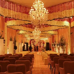 The view from the back of the hall, capturing the sheer scale and impact of the floral ceiling installation. The design transforms the entire venue into a fragrant, festive sanctuary.