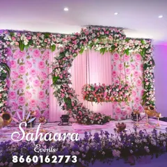 For a truly special naming ceremony or baby shower, we designed this breathtaking floral swing. The crescent moon shape, covered in soft pink and white flowers against a rose-patterned backdrop, creates a magical setting to welcome your little one.