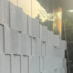 A close-up of the 'Wings of Sahyadri' facade in Lonavala. The three-dimensional blocks create a captivating play of light and shadow that changes throughout the day, adding a dynamic quality to the architecture.