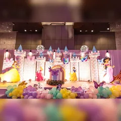 This expansive castle stage features multiple towers and cutouts of famous princesses, creating a complete Disney princess party scene perfect for a magical first birthday.