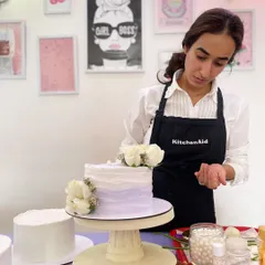 Here I am at work, adding fresh flowers to a lavender ombre cake. It's these final, delicate touches that I enjoy the most.