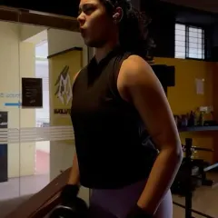 Harshitha focuses on a dumbbell exercise during her personal training session. My programs for women focus on building functional strength, which improves metabolism and overall health.