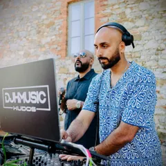 A classic shot of me DJing in Tuscany. The focus is intense as I line up the next track, making sure the flow of the party never drops.
