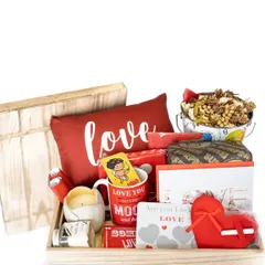 This "language of love" hamper is perfect for Valentine's Day or an anniversary. It's packed into a wooden tray and includes a "Love" cushion, a romantic mug, a scented candle, and other sweet treats.