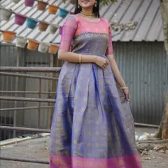 A full-length view of a beautiful long gown made from upcycled silk saree fabric. The combination of lavender and pink with a traditional border makes it a unique and sustainable ethnic outfit.