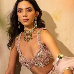 An artistic shot from a campaign for Surabhi Chopra. The styling, featuring a pink mirror-work lehenga and emerald jewellery, was designed to evoke the feeling of a beautiful, blooming garden.