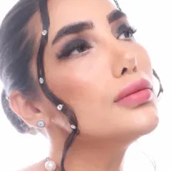 A detailed shot focusing on the delicate rhinestone work along the hairline, paired with a dramatic smokey eye. This shows how I use makeup elements to frame the face and create a cohesive, artistic vision.