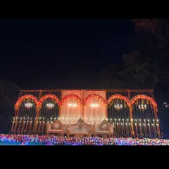 This is how we set the stage for a grand reception in Lonavala. The elegant gold-arched backdrop, sparkling chandeliers, and warm lighting created a royal ambiance for the couple's big night.