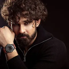 A powerful male portrait with dramatic, low-key lighting. The dark background and intense gaze create a moody and cinematic headshot, showcasing the model's versatility.