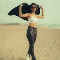Using a black jacket as a prop to create dynamic shapes against the sky. This beach portrait is a great example of how to add movement and interest to a fashion shot.