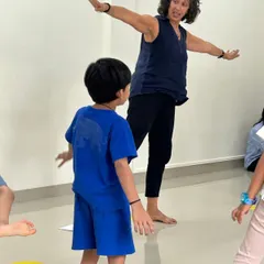 Movement is integral to our teaching. Here, Naheed leads a student in a physical exercise that mirrors a musical idea, embodying the principle of learning music with the whole body.
