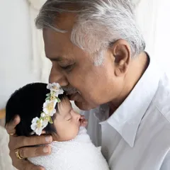 The bond between a grandparent and a grandchild is truly special. I love capturing these multi-generational portraits, like this grandfather's gentle kiss.