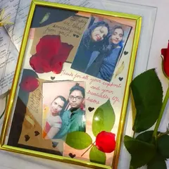 This custom frame combines photos with preserved natural elements like a real rose and leaves. It's a handmade piece that mixes pictures with handwritten notes for a scrapbook feel.