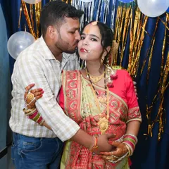 A sweet kiss from the husband during an indoor maternity celebration. We capture the love and support of family during this special time.