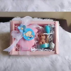 A sweet and simple baby shower return favor box. This set contains a handmade goat milk baby romper soap and a cute teddy bear with a balloon candle.