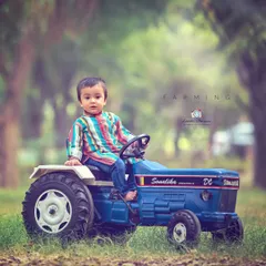 From the farm to the photo. This themed shoot with a toy tractor brings a touch of rustic charm and allows for imaginative play during the session.