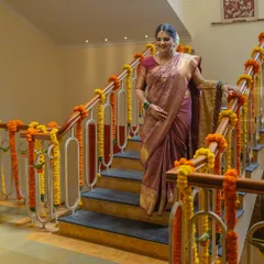 A beautiful full-length portrait of the bride on the staircase of her home, just before the ceremony begins.