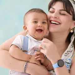 The purest joy captured in a mother-and-son portrait. The light blue background adds a soft pop of color while keeping the overall feel bright, happy, and focused on their infectious laughter.