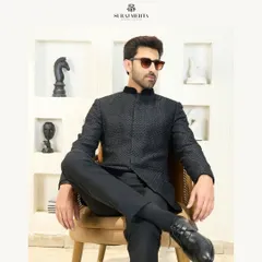 I redefine traditional attire with this sleek black Jodhpuri suit. The modern, sharp cut and textured fabric seamlessly blend heritage with contemporary flair, making it a perfect choice for a bold and stylish statement at a reception or formal gathering.