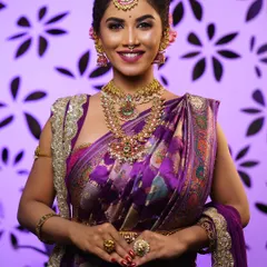 Here, the traditional updo is paired with heavy temple jewelry and a vibrant silk saree. The hairstyle is designed to balance the entire look, creating a regal bridal appearance.
