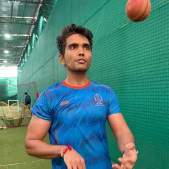 A player focuses on a simple ball toss drill, a moment of calm concentration amidst the intense net session.