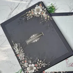 This design is for the modern couple seeking elegance and sophistication. The deep charcoal box is adorned with delicate, embossed floral artwork, creating a beautiful contrast. It's a chic and contemporary take on the classic wedding invitation.