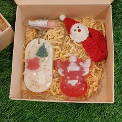 A look inside one of my curated Christmas gift hampers, featuring a crochet Santa bookmark, handmade soaps, a wax sachet, and lip balm.