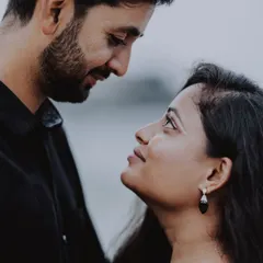 An intimate close-up portrait that focuses on the silent conversation between a couple, highlighting the emotion in their eyes.