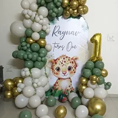 This "Wild One" safari theme is one of my most popular requests for first birthdays. I use a stylish palette of sage green, white, and gold chrome balloons to create a full arch around a personalized backdrop, complete with a cute leopard cub illustration and a number '1' balloon tower.