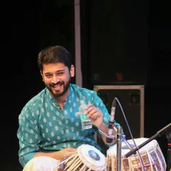 A candid moment on stage, taking a quick water break. One sip at a time, folks!