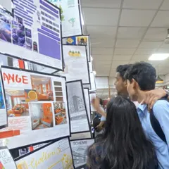 Students proudly display their interior design mood boards and technical drawings at the semester-end exhibition.
